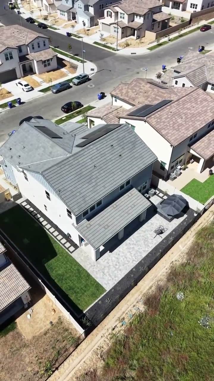 Aerial view of a finished backyard and covered patio in a new-home community by Five Stars Builders