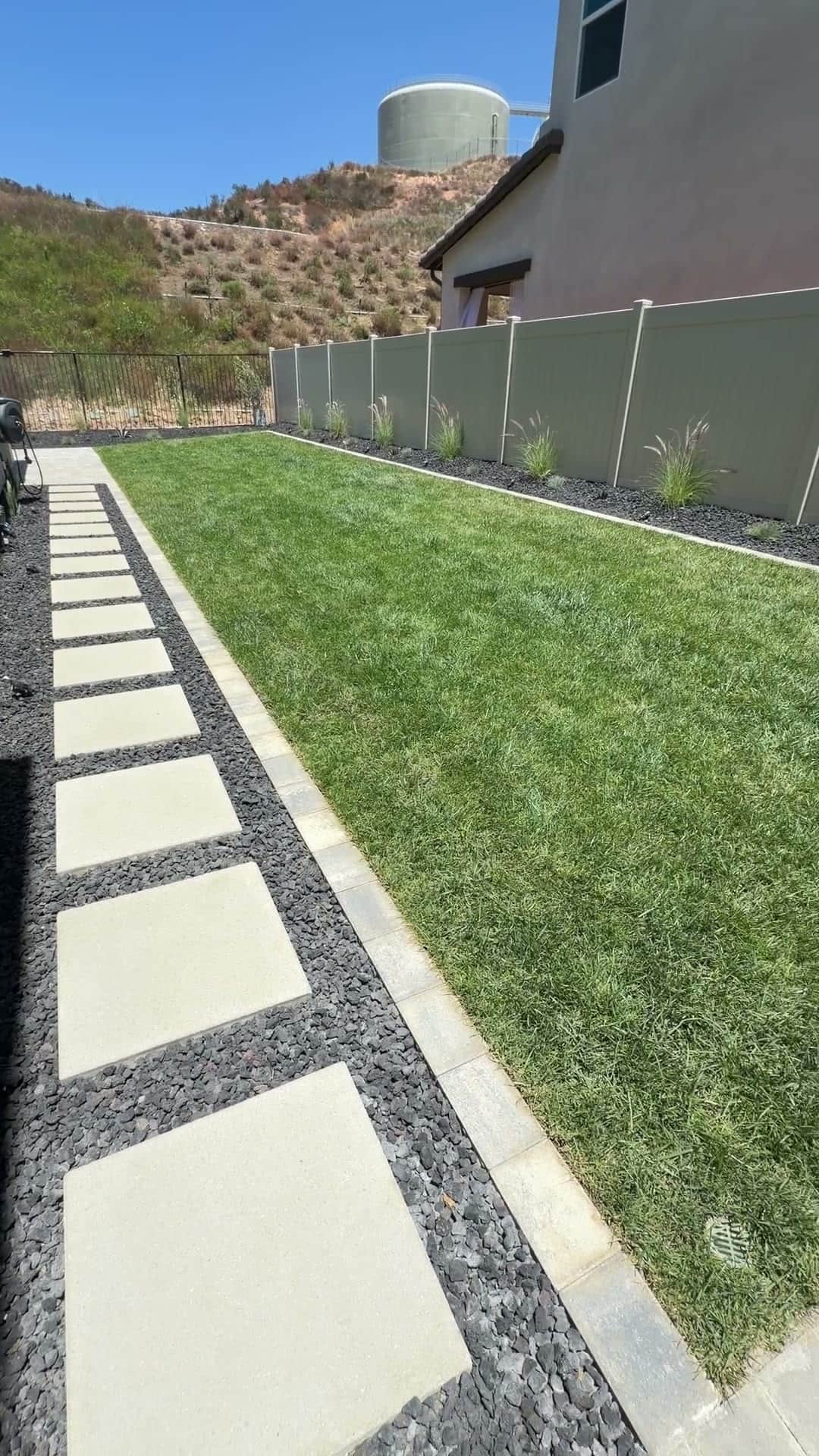 Completed paver patio and turf backyard by Five Stars Builders