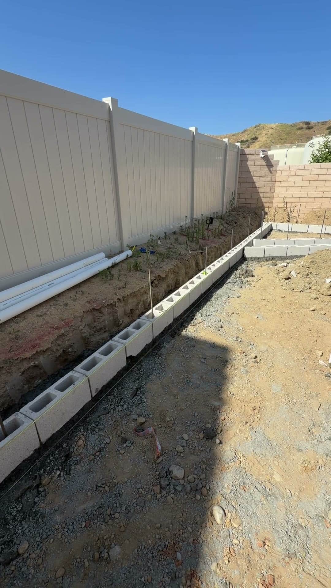 Block wall and foundation work in progress on a Five Stars Builders backyard project in Southern California