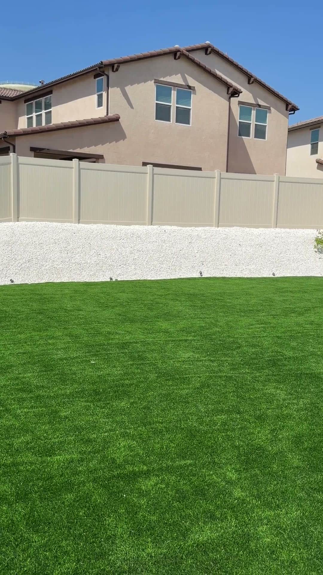 Finished turf lawn and landscaping completed by Five Stars Builders in a new-construction Southern California backyard
