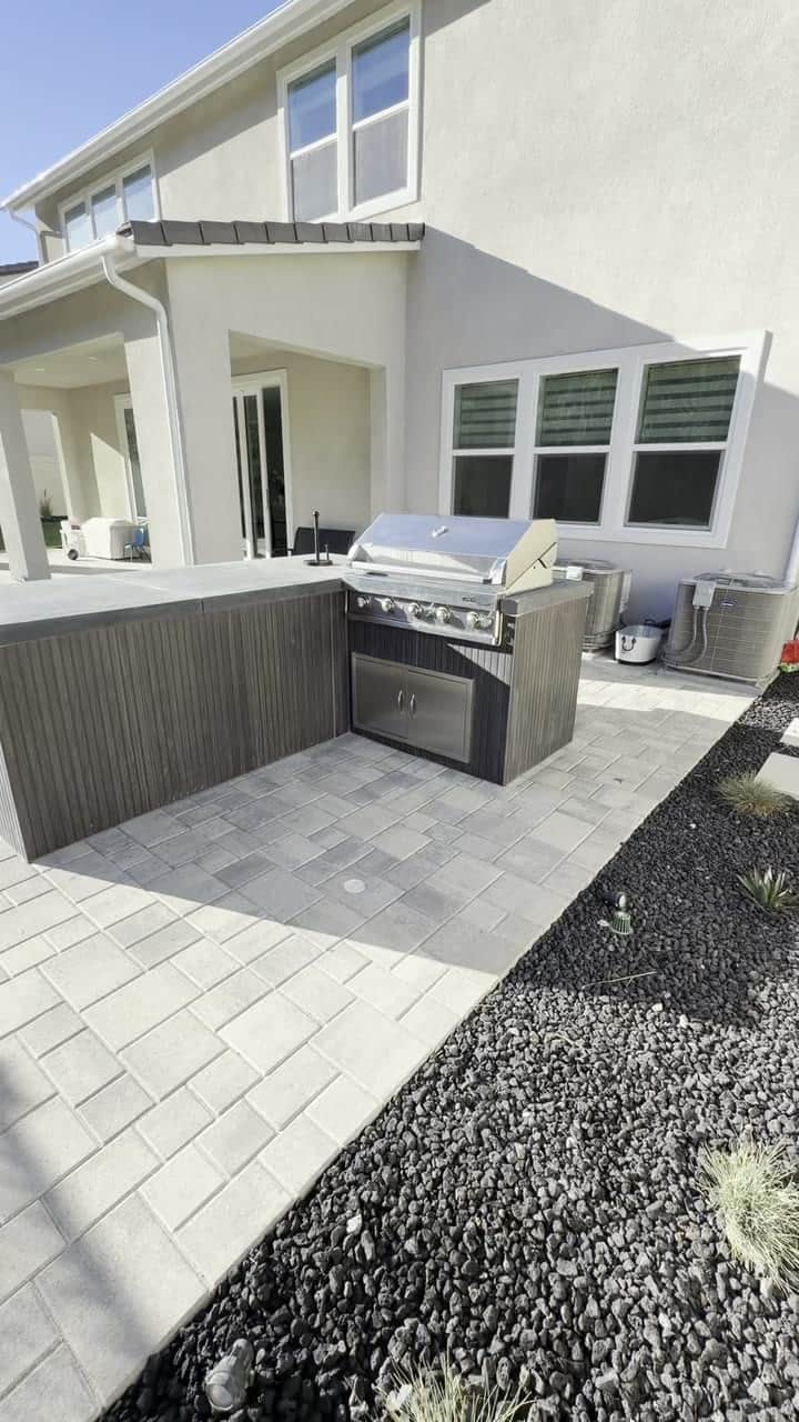 Built-in outdoor kitchen with BBQ island completed by Five Stars Builders in a Southern California backyard