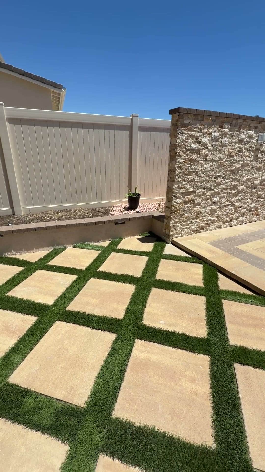 Completed paver patio and artificial turf hardscape installed by Five Stars Builders in a Southern California backyard